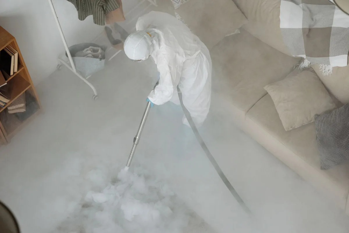 Biohazard cleanup technician in protective equipment, Avoca, IA
